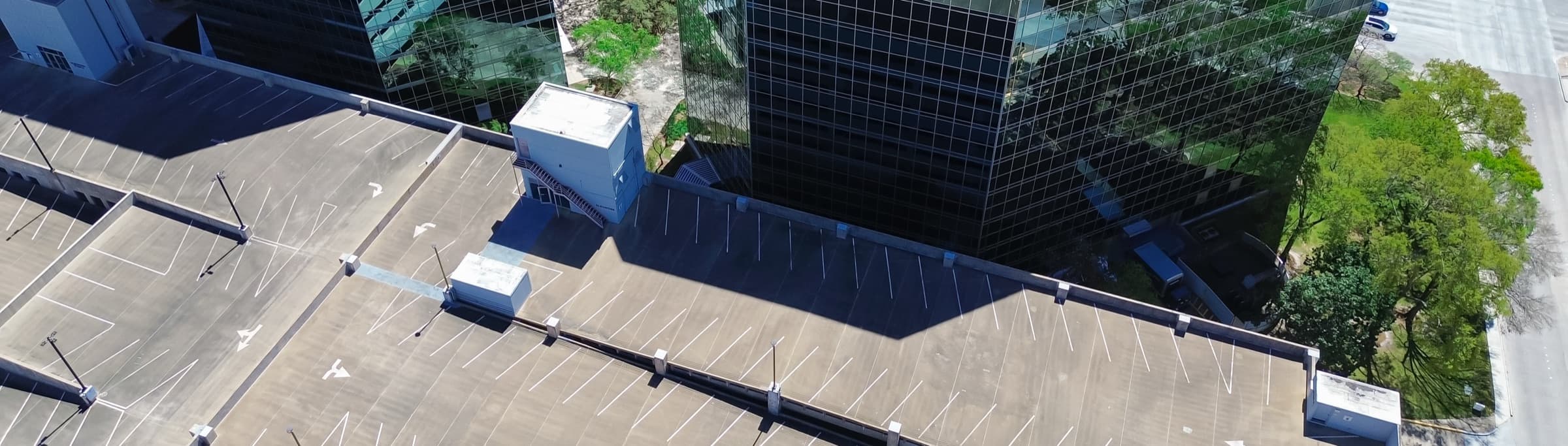 Aerial view of a commercial parking asset beside an office tower